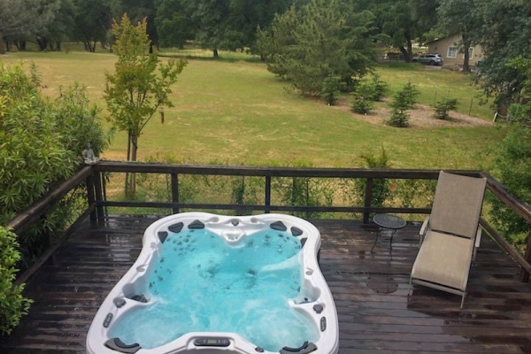 Backyard deck in Redding CA with hot tub installed by Palo Cedro Pool and Spa.
